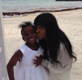 Tomeka and Alianna are posing near a beach 